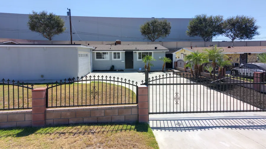 Block and wrought iron gates at the front of 14020 Bora Dr